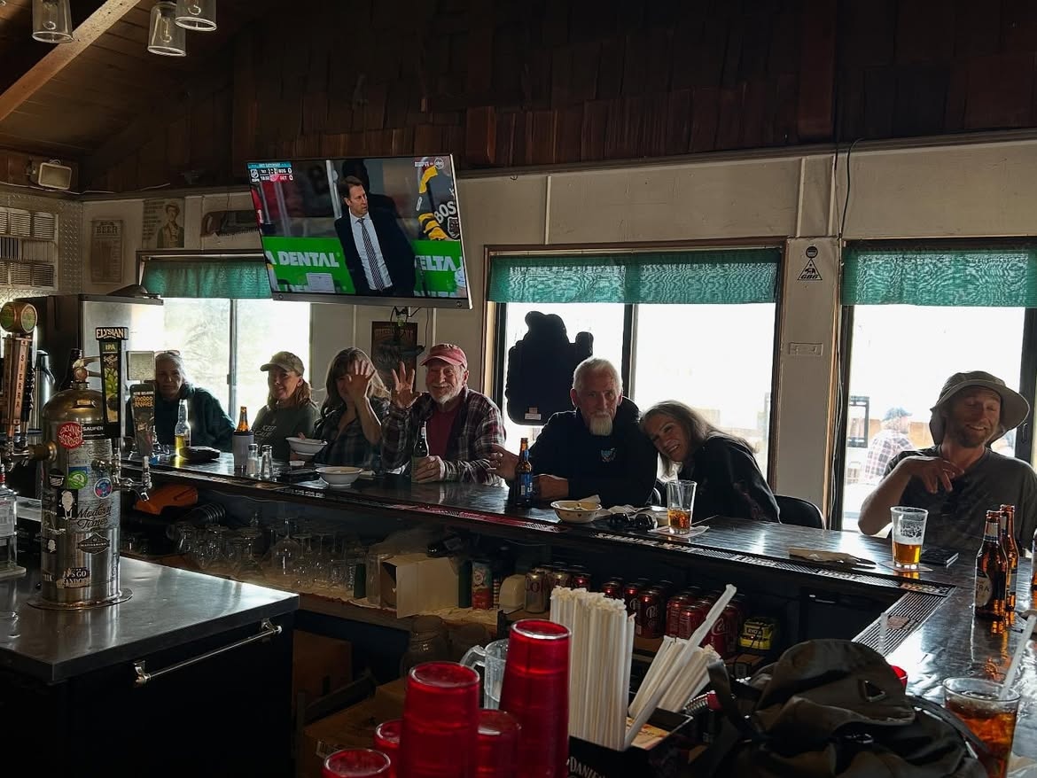 The bar at Grumpy Bear's on a weekday afternoon, regulars along it under the taps and the television