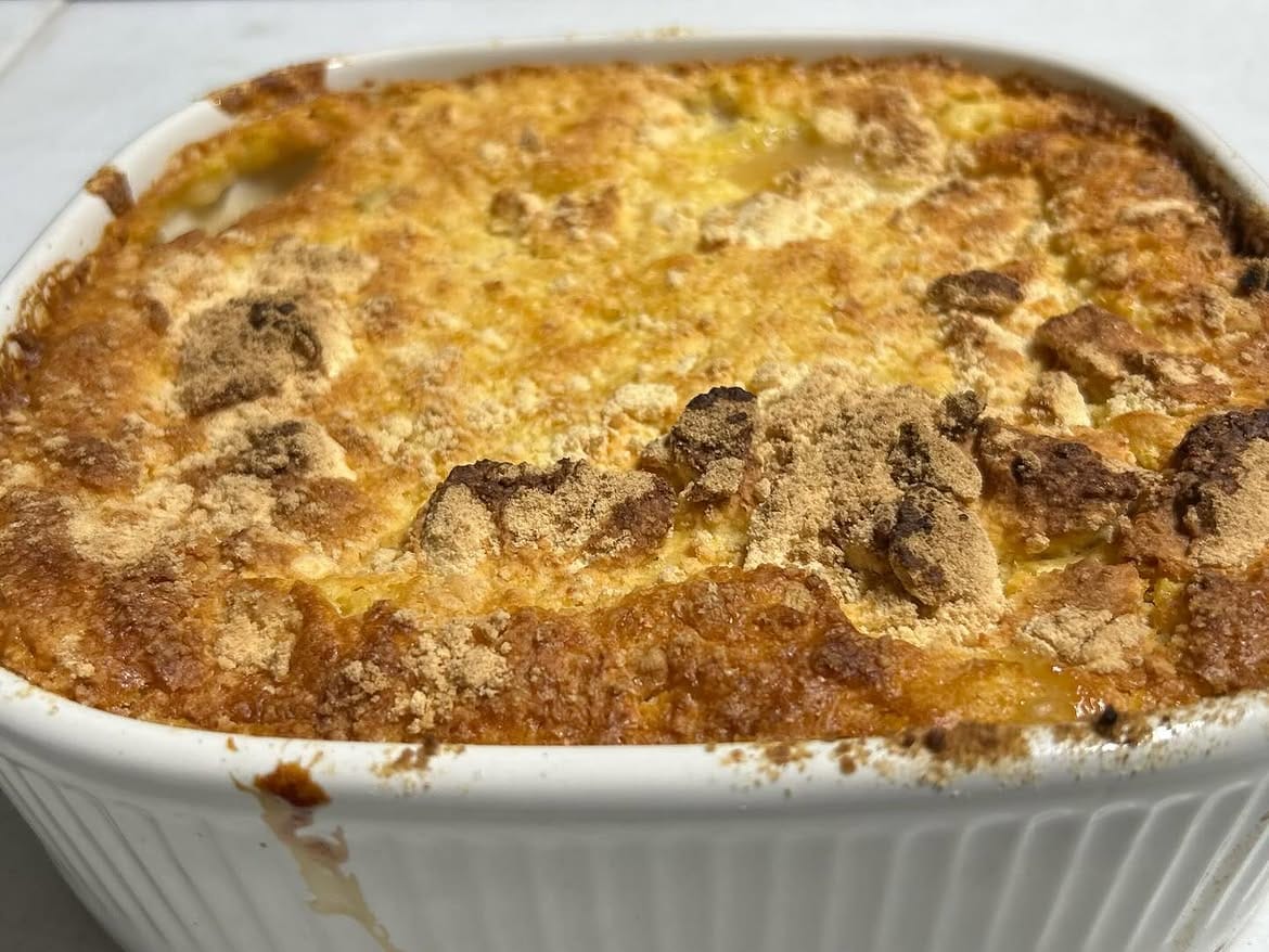 A golden-crusted casserole fresh from the oven in a white dish
